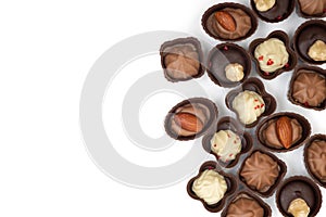 Collection of handmade chocolates on a white background. View from above