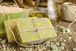 Collection of handmade, natural organic soap and cosmetic oil on wooden background. Spa products.