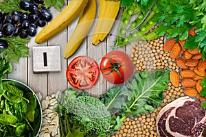 Collection iron rich foods as broccoli, grapes, banane, Greenpeace, almond, tomato, beef, oats, parsley and soya seeds.