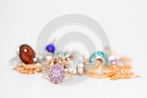 Collection of jewelry with beautiful golden ring with purple stone isolated on white background