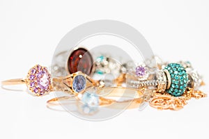 Collection of jewelry with beautiful golden ring with purple stone isolated on white background