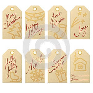 Collection of kraft paper christmas gift tags with hand drawn holiday symbols and handwritten greetings