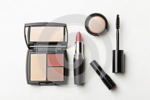 Assorted makeup products arranged on a white surface