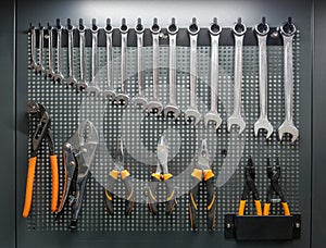Collection of mechanic hand tools hanging on tool board