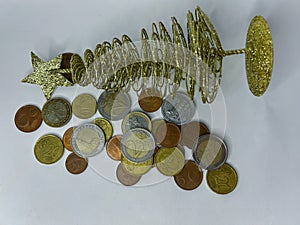collection of mixed euro coins scattered on a white surface. The image shows various denominations in different metallic