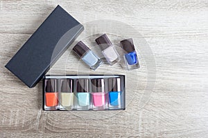 Collection of multi-colored bottles of nail polish. Layout for design on a gray background