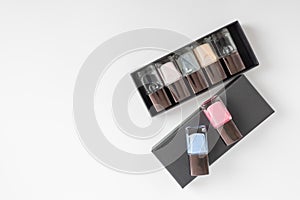 Collection of multi-colored bottles of nail polish. Layout for design on a gray background