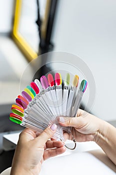 Collection of nails color polish samples. A palette of nail designs of different colors with gel polish. Transparent