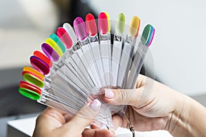 Collection of nails color polish samples. A palette of nail designs of different colors with gel polish. Transparent