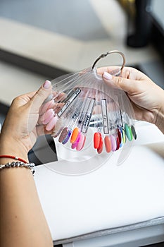 Collection of nails color polish samples. A palette of nail designs of different colors with gel polish. Transparent