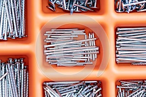 Collection of nails, screws and bolts in plastic box