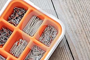 Collection of nails, screws and bolts in plastic box