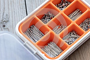 Collection of nails, screws and bolts in plastic box