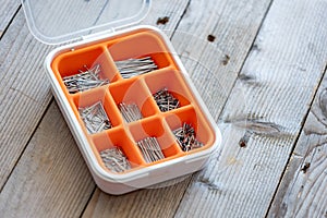 Collection of nails, screws and bolts in plastic box