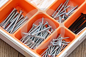 Collection of nails, screws and bolts in plastic box