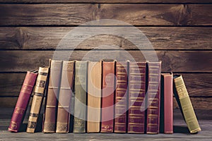 Collection of old books on wooden background, showcasing literary knowledge