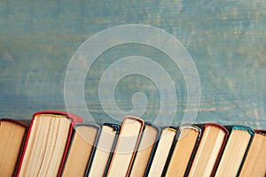 Collection of old books on wooden background. Space for text