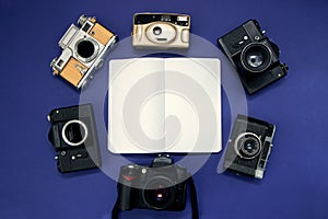 Collection of old vintage photo cameras on blue background