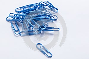 A collection of paperclips on a white surface