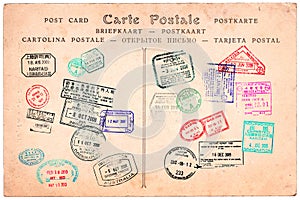 Collection of passport stamps on a vintage postcard