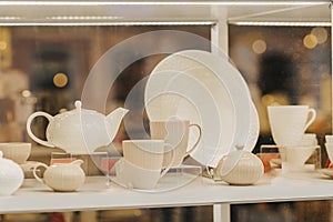 Collection of porcelain and ceramic tableware, crockery for sale behind store window
