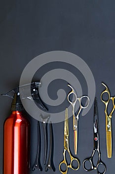 Collection of professional hair dresser tools arranged on dark background