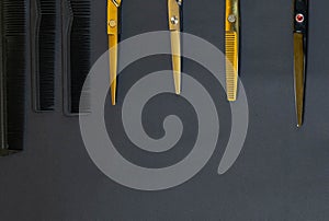 Collection of professional hair dresser tools arranged on dark background