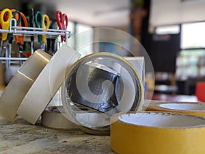 A collection of rolls of scotch tapes sellotape on a table