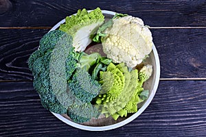 Collection of Romanesco broccoli and cauliflower on the kitchen table. Low-calorie nutritional products