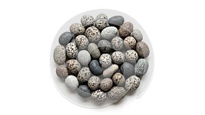 A collection of rounded pebbles is arranged in a circular pattern