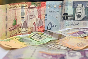 Collection of Saudi Arabia money background, different Saudi riyals collection of 500, 100, 10, 5 and 1 riyal, selective focus