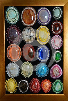 Collection of semi precious brooch on the wood frame