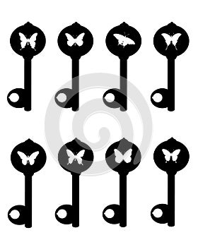 A collection of silhouettes of old keys with butterflies