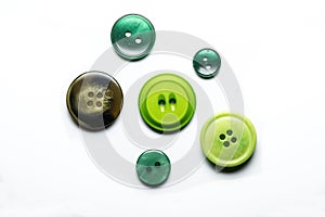 Collection of six sewing buttons on white background