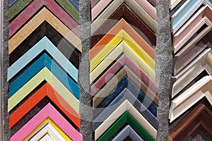 A collection of solid wood photo picture frame corner samples are displayed on a table