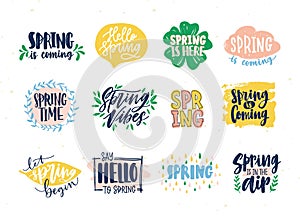 Collection of spring slogans or phrases written with creative fonts and decorated by springtime natural elements. Set of