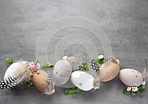 Collection of stylish colors eggs with flowers for Easter celebration on grey background.