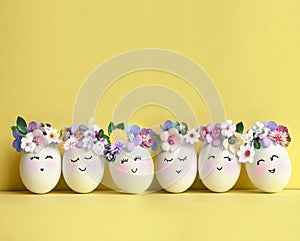 Collection of stylish colors eggs with flowers for Easter celebration on yellow background.