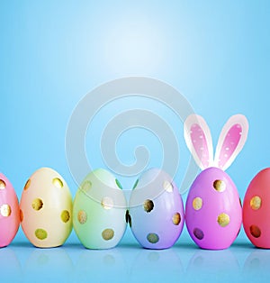 Collection of stylish colors eggs with golden circles for Easter celebration on blue background.