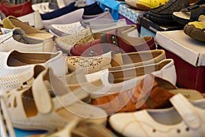 A collection of summer women's shoes is on display in the shop window