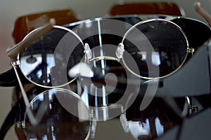 Collection of sunglasses on big reflection mirror