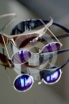 Collection of sunglasses on big reflection mirror