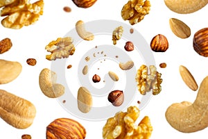 Collection of tasty crispy Hazelnut, Wallnut, Pecan nut, almond and sultana raisins falling isolated on white background. Concept