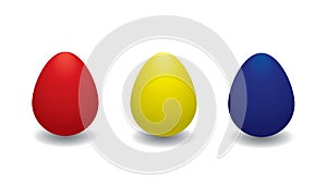Collection of three colored Easter eggs on a white background.