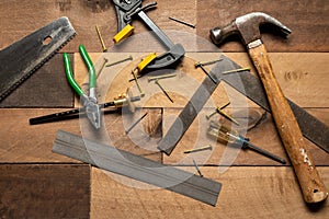 A collection of tools including a hammer, pliers, and a tape measure