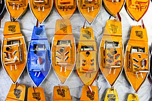 A collection of traditional boat toys in a merchandise booth at a festival in Bandung City, West Java.