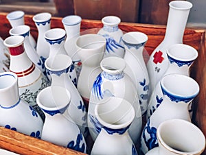 Collection of traditional Japanese ceramic white and blue sake pitchers or tokkuri