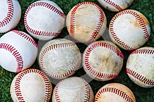 Collection of used baseballs on turf for sports background