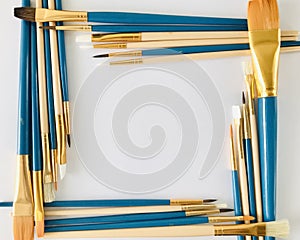 Collection of various brushes arranged in a rectangular frame on a white background.