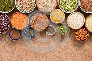 Collection of a various of legumes, beans, grains and seeds in bowls. Top view, flat lay, space for your text, border
